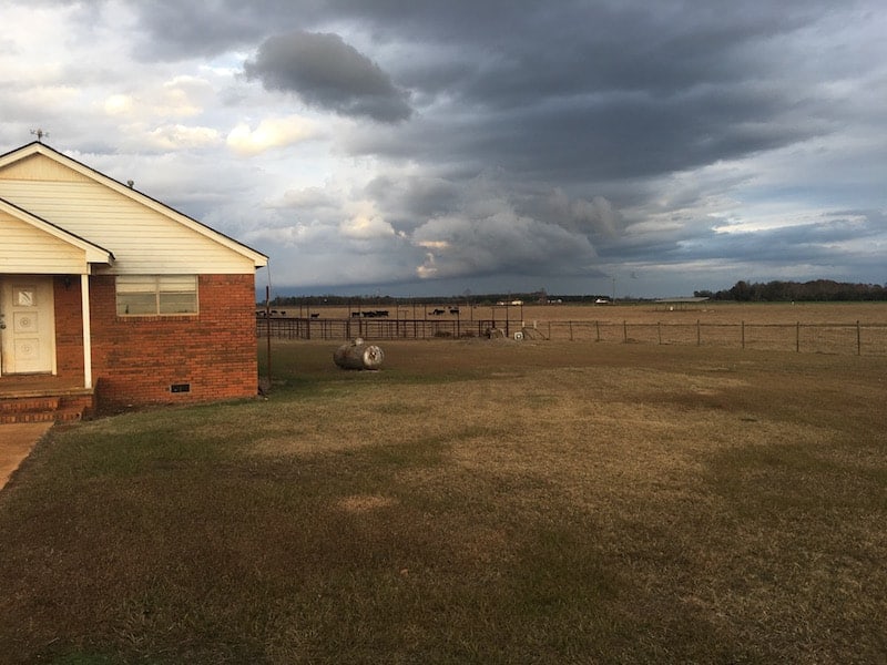 Pasture with dark clouds rolling in