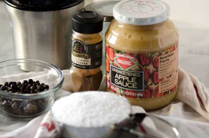 spices and ingredients on table next to spice grinder for pork belly curing 