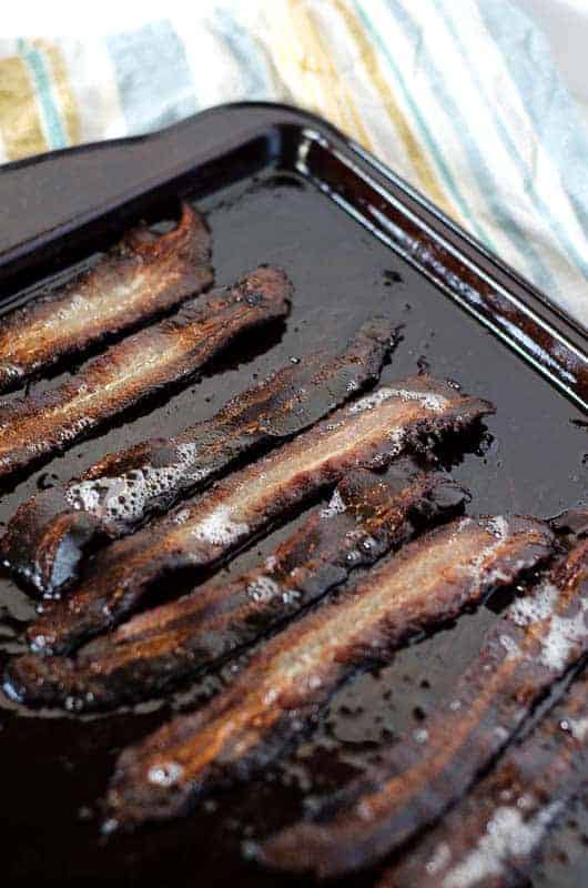 slices of bacon on a baking sheet