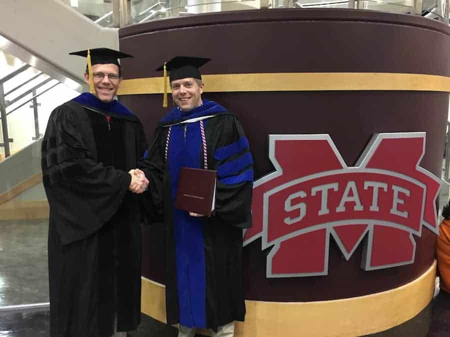 Two men shaking hands at MSU graduation ceremony