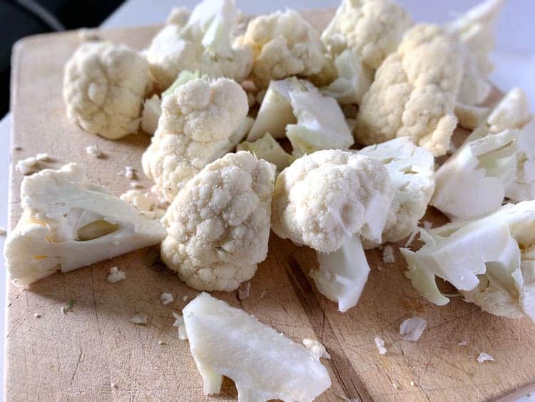 cauliflower florets on cutting board