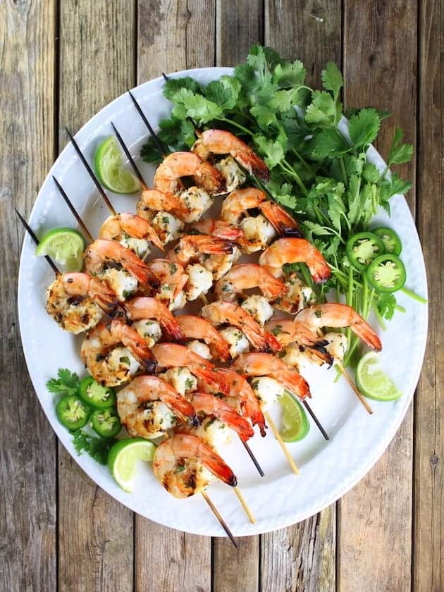 overhead view of platter with skewers of grilled shrimp