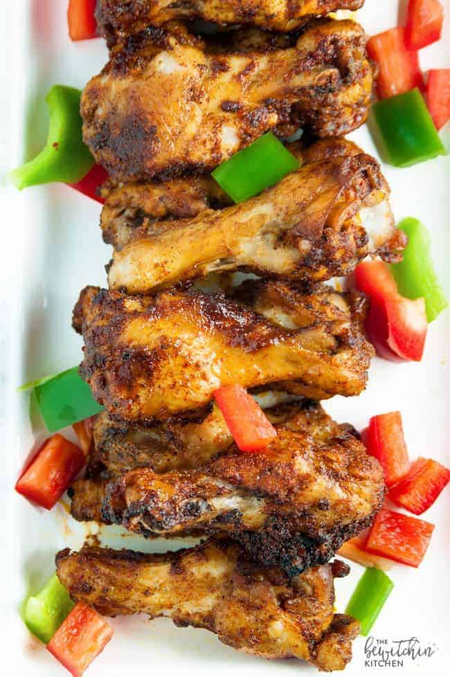 Overhead view of a line of fajita baked paleo chicken wings