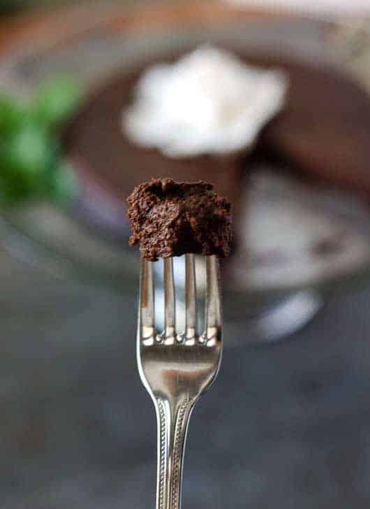 bite of chocolate cake on the tip of a fork