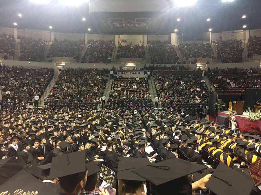 MSU graduation ceremony in stadium with tops of graduation hats in view