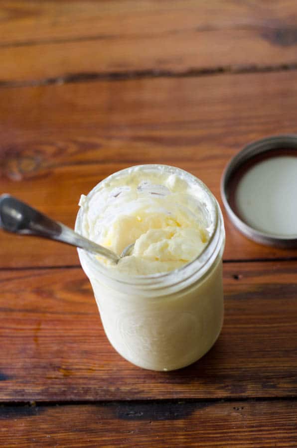 overhead view of mason jar full of mayonnaise with spoon in it