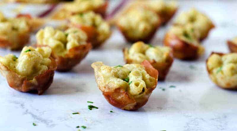 close up side view of gluten free mac and cheese bites on a counter