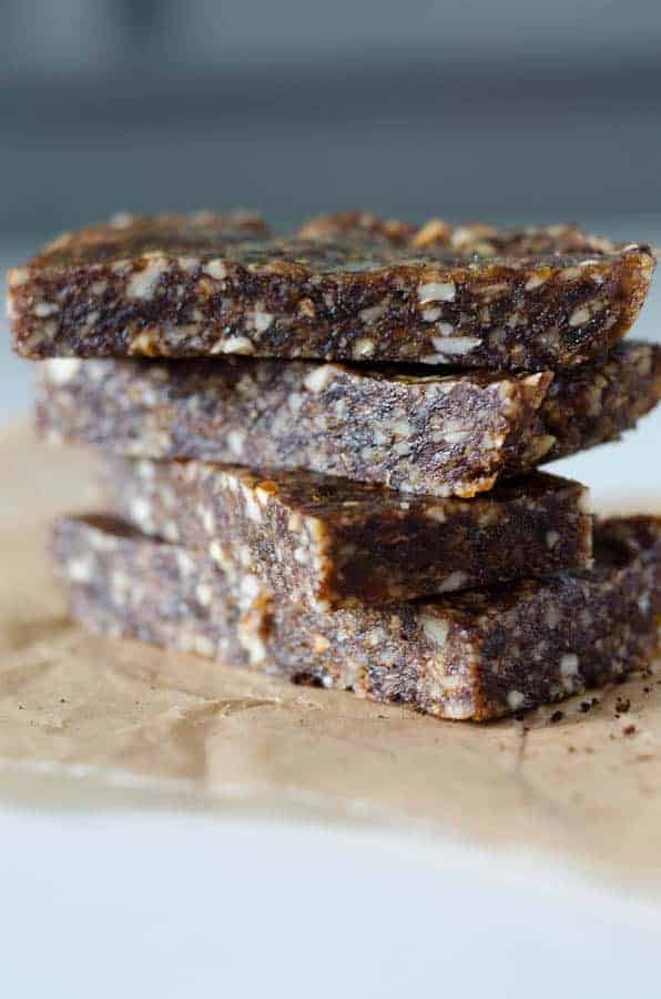 Close up side view of espresso date bars stacked on top of each other