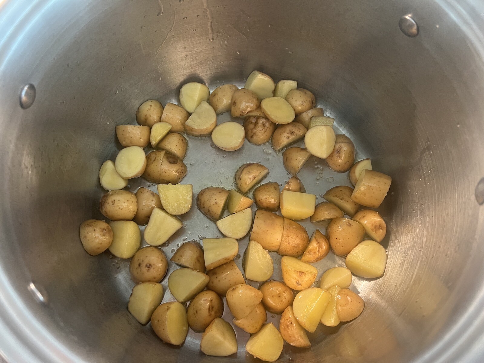 potatoes sautéing in the bottom of a stockpot
