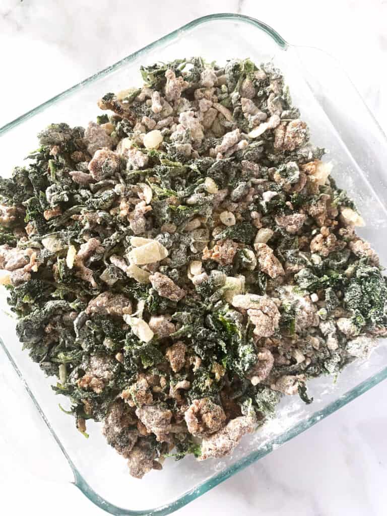 Overhead view of spinach egg casserole coated with flour