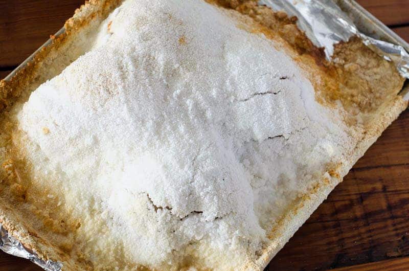 Overhead view of baked chicken covered in a salt crust