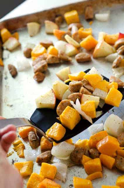 sheet pan meal with a person serving with a spatula