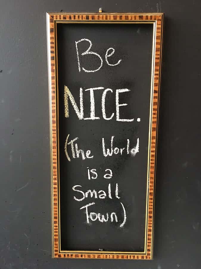 sign reading "Be Nice. The world is a small town."