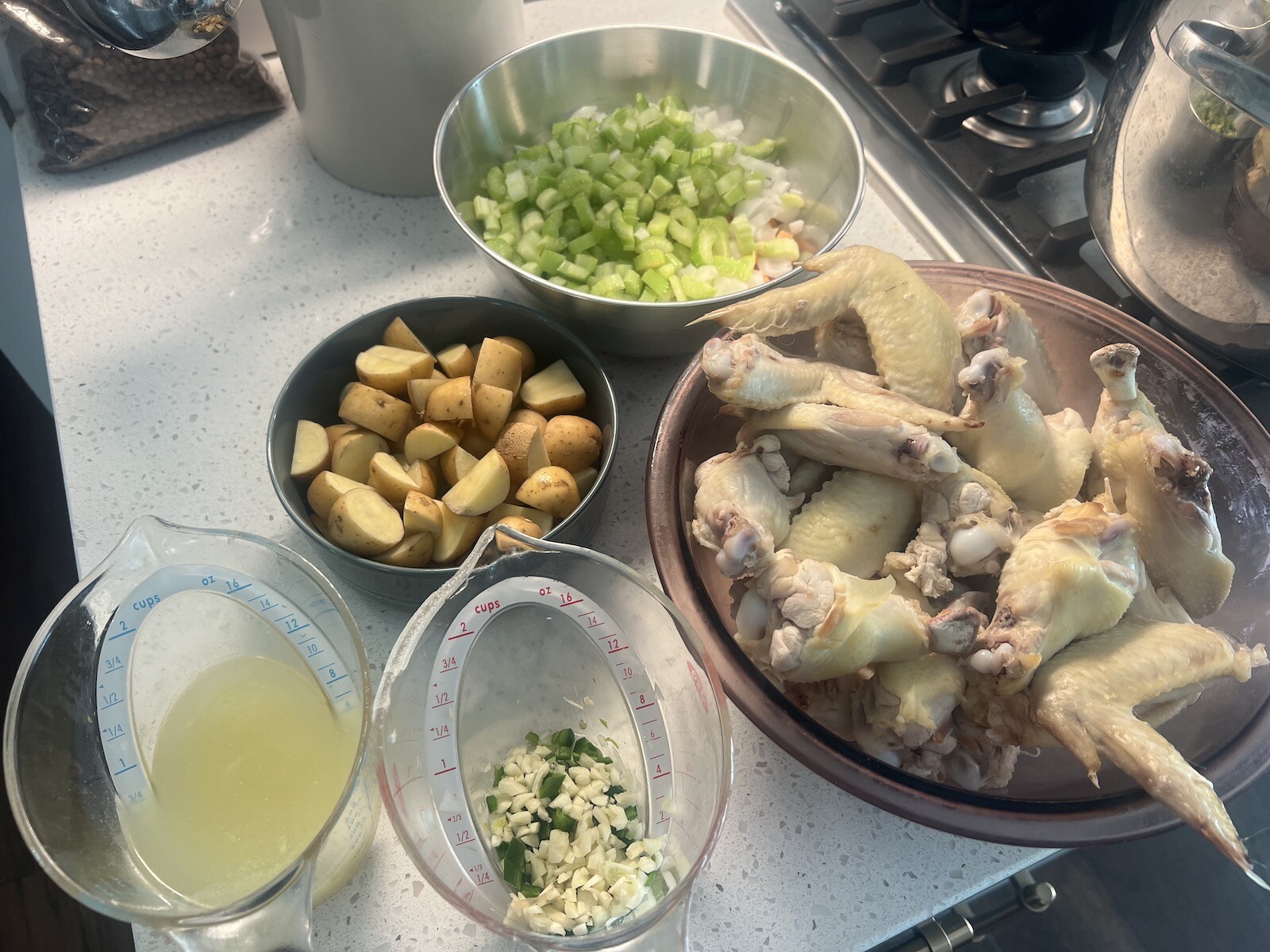 ingredients for bahamian chicken souse on counter in bowls