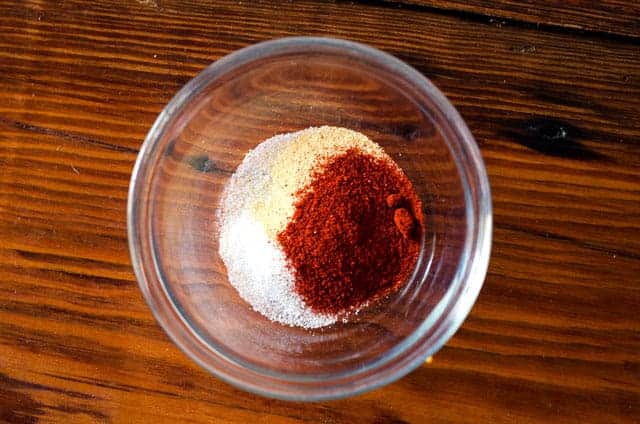 overhead view of bowl of spices on wooden table