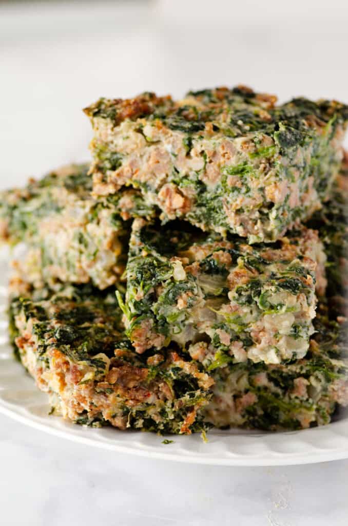 squares of spinach egg casserole stacked on a plate